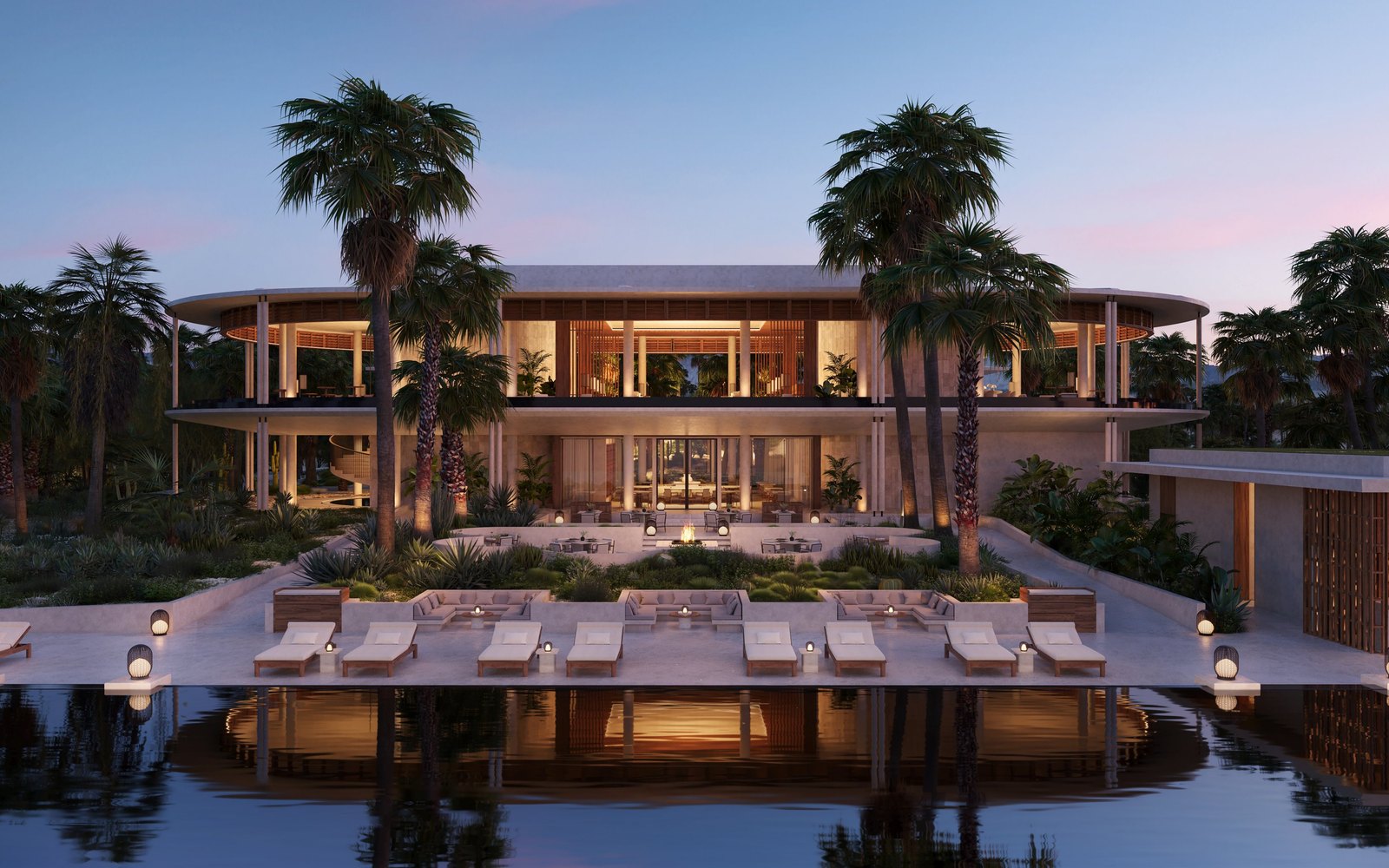 Casa Grande at Amanvari at sunset, with palm trees and poolside loungers