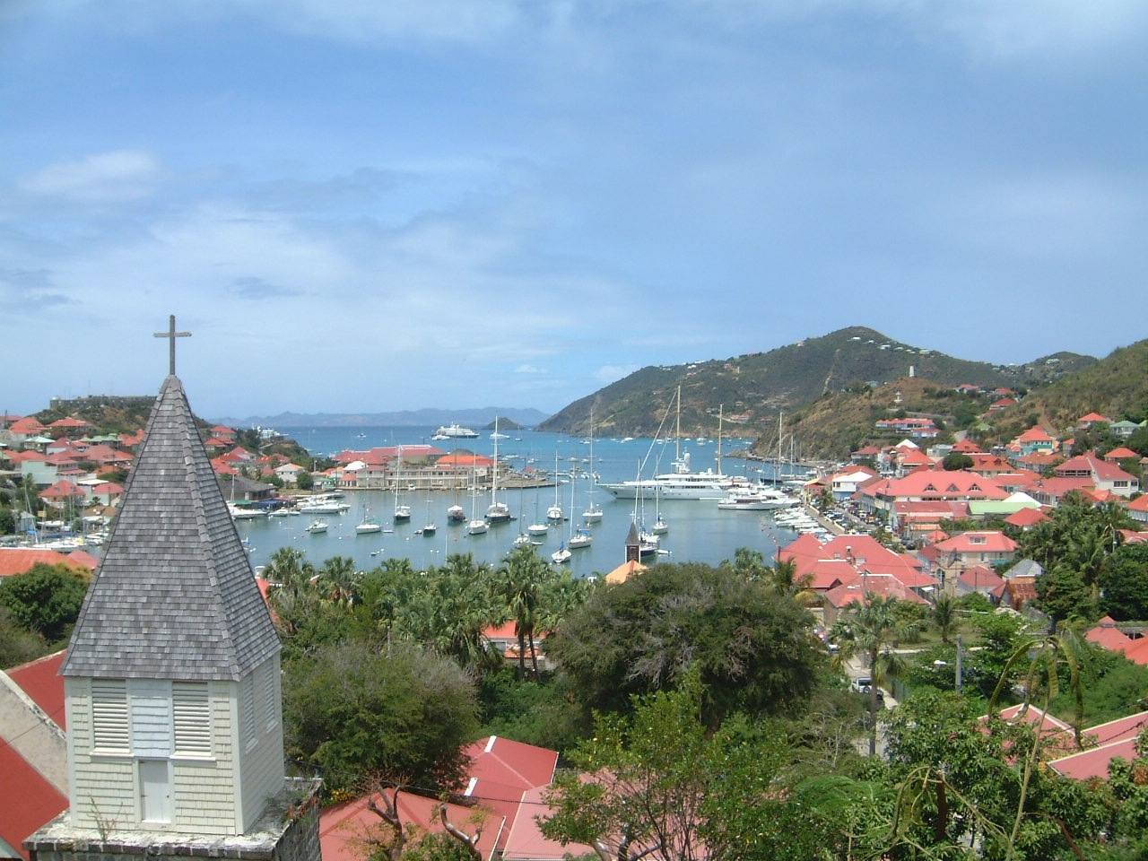 Gustavia harbour on St. Barths with yachts at anchor and the church steeple in the foreground
