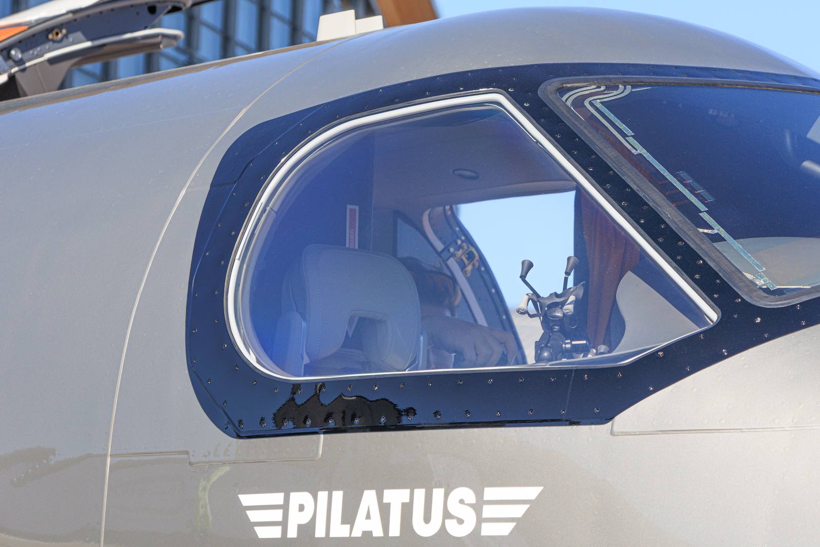 Close-up of a Pilatus PC-24 cockpit windows with the Pilatus logo