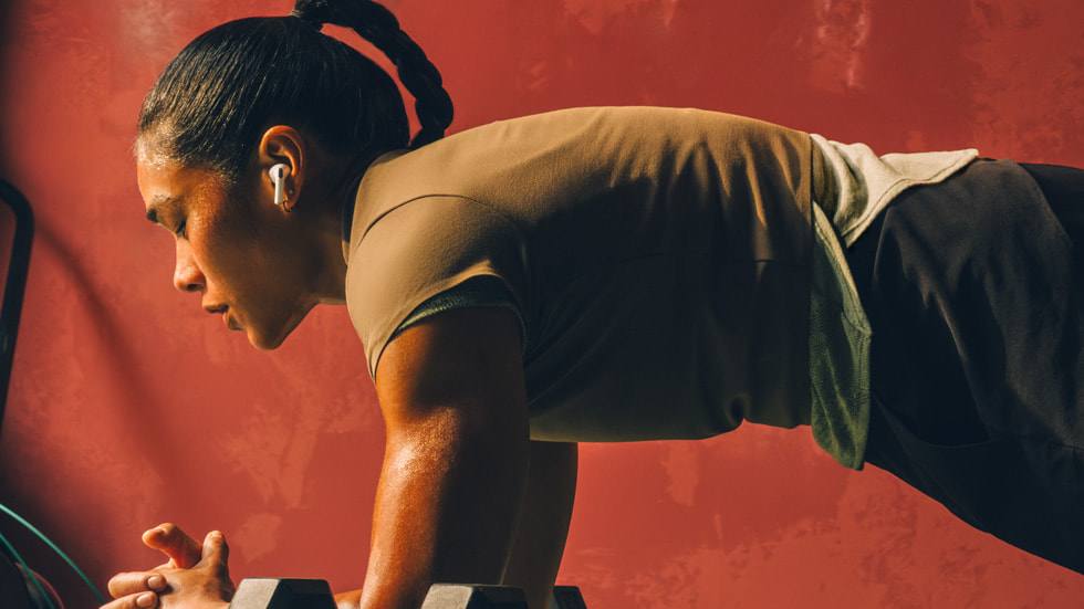 A woman working out while wearing AirPods Pro 3