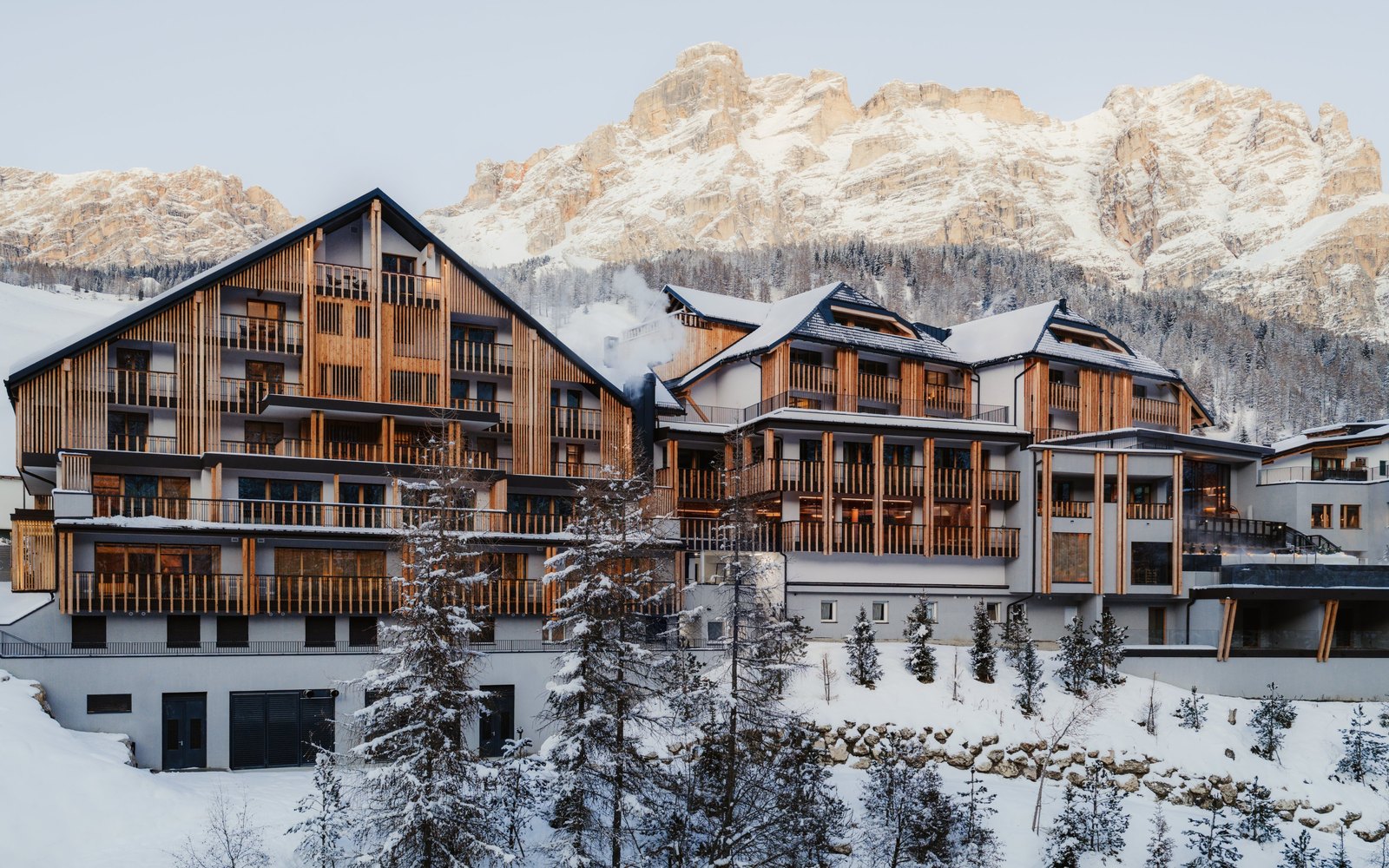 Aman Rosa Alpina exterior with snow-covered Alpine peaks in the background