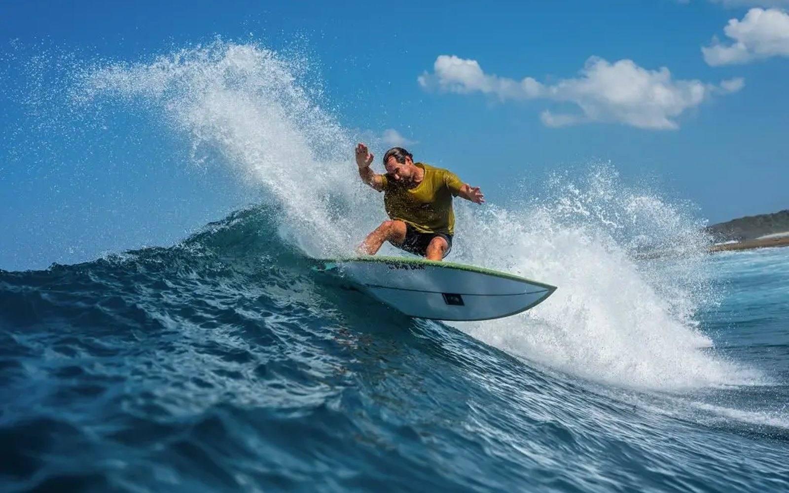 A surfer riding a wave at NIHI Rote