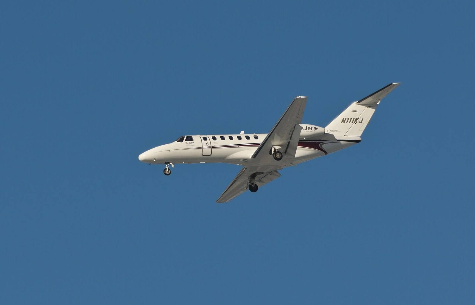 A Cessna Citation CJ3 in flight against a clear sky
